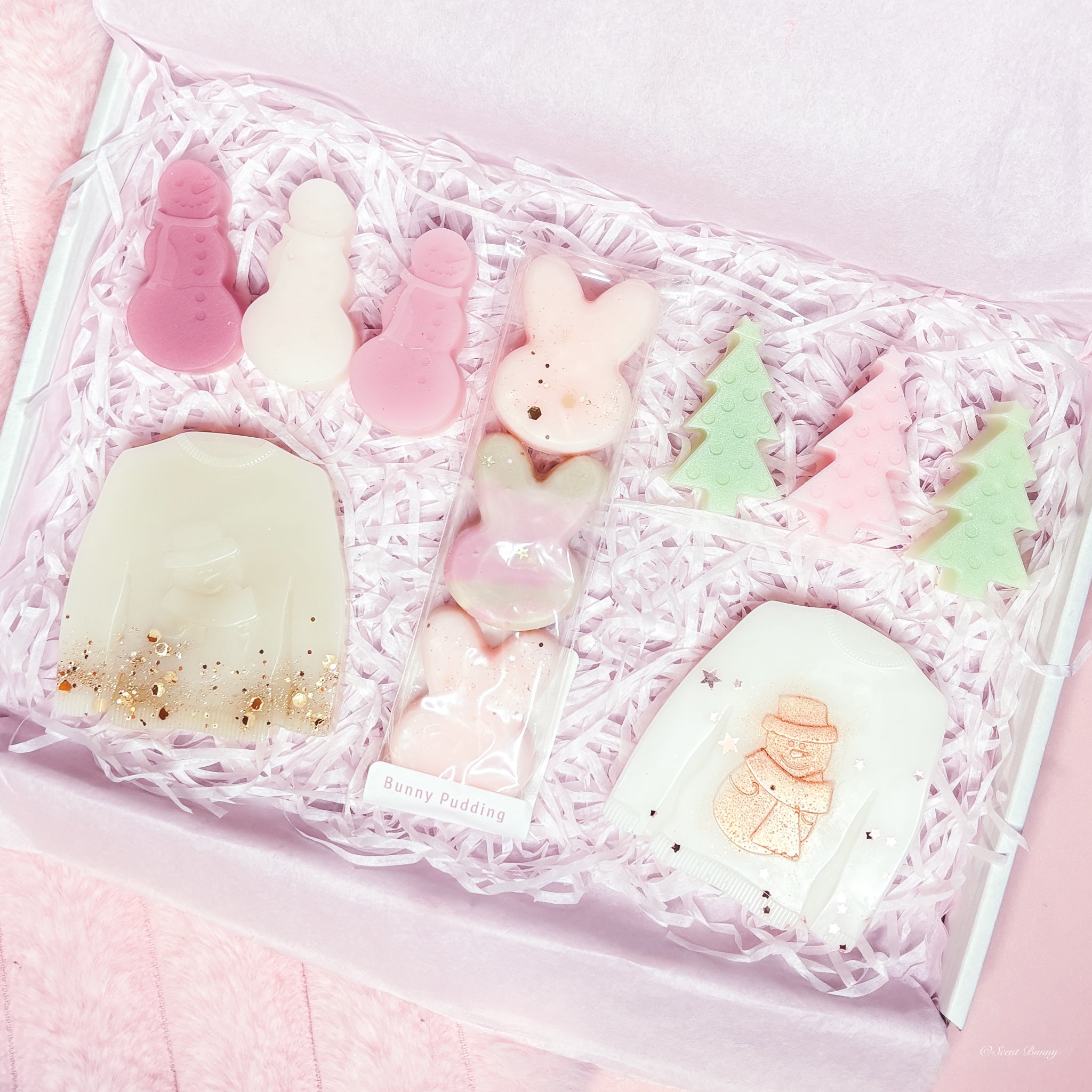 December Bunny Box festive wax melt collection with jumper, snowman, tree, and bunny shapes by Scent Bunny, handmade Belfast.​

Five-scent December Bunny Box wax melts Blanc, Toasty, Quartz, Cedar, Bunny Pudding by Scent Bunny, handmade wax melts Belfast.​